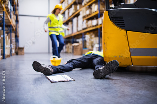 An injured worker after an accident in a warehouse. photo