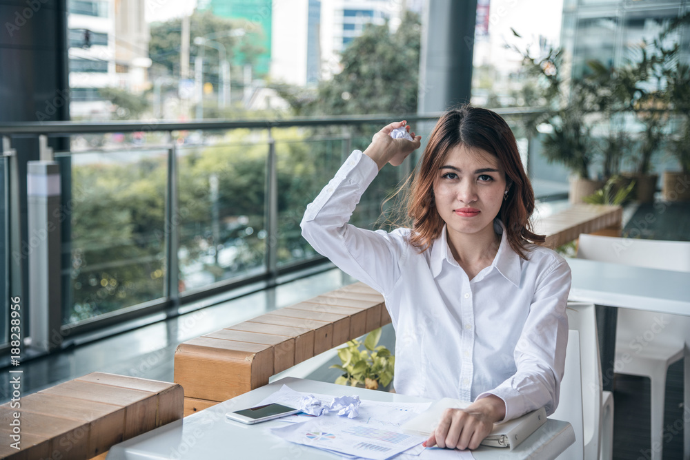 Portraits of beautiful asian woman is destroy financ chart document and feeling Portraits of beautiful asian woman is destroy financ chart document and feeling