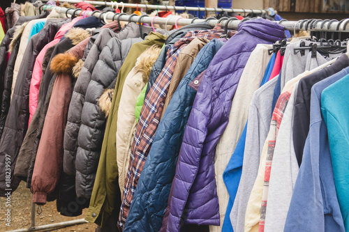 Fashion winter coats hanged on a clothes rack.