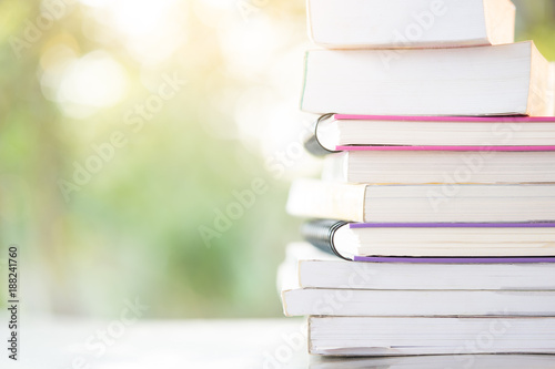 stack books with green light and bokeh background