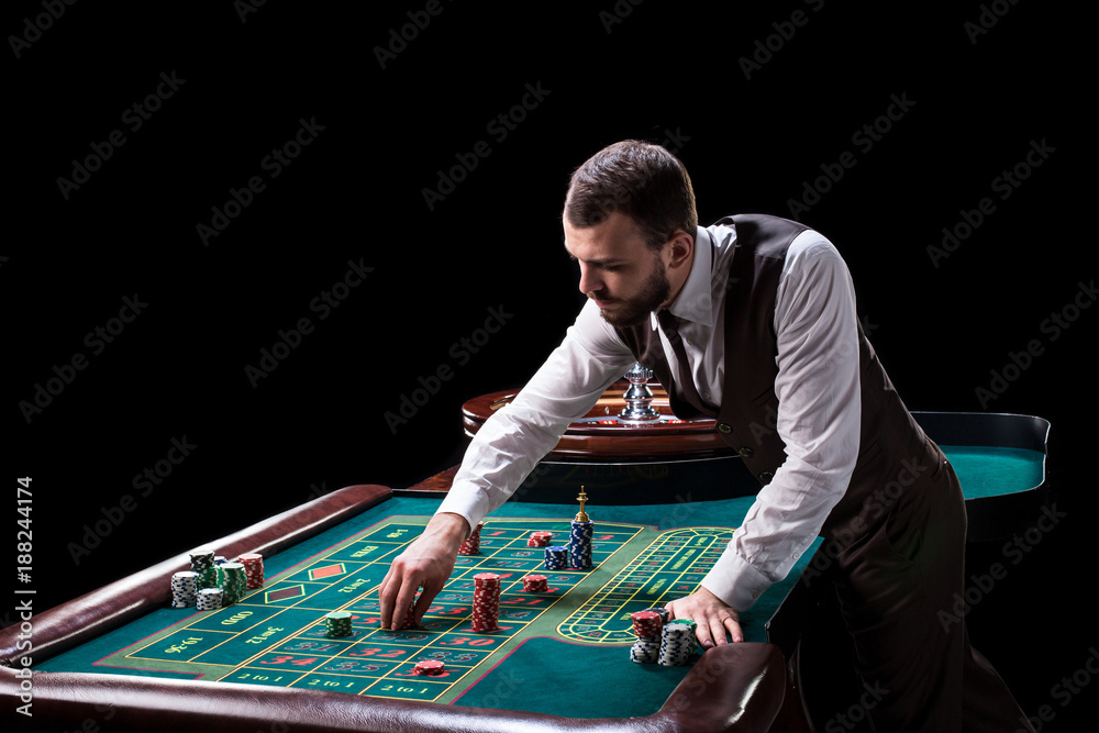 Croupier behind gambling table in a casino. Croupier behind gambling table in a casino.
