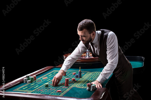 Croupier behind gambling table in a casino.