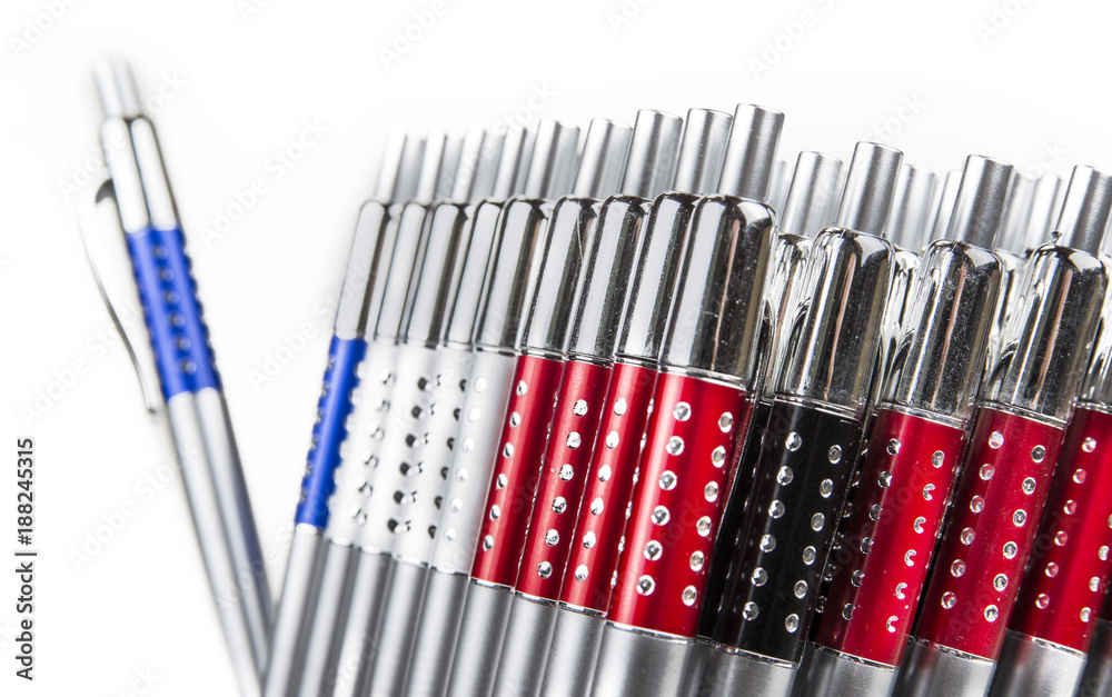 New pens in holder in rows on white background New pens in holder in rows on white background