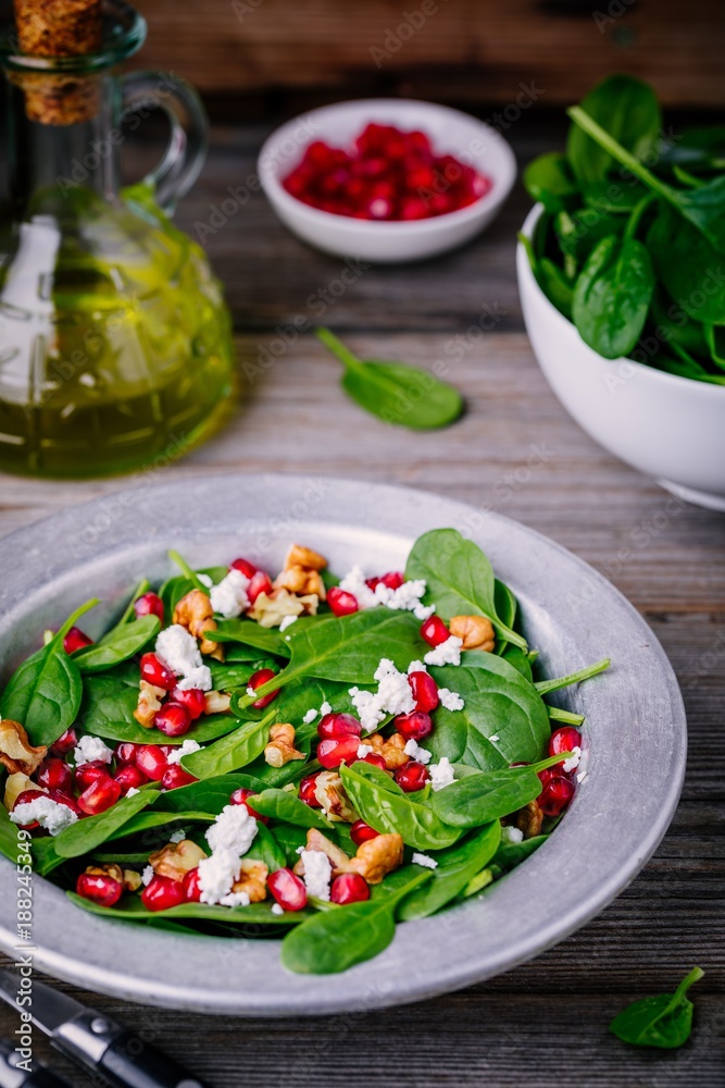 Fresh green salad with spinach, walnuts, feta cheese and pomegranate Fresh green salad with spinach, walnuts, feta cheese and pomegranate