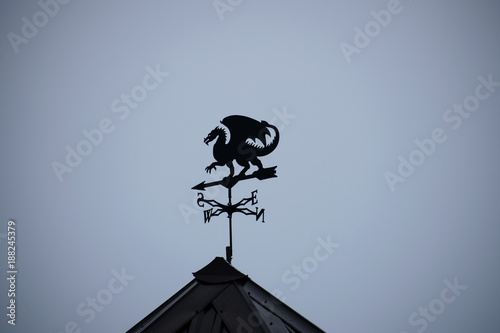 Black dragon wind vane against the sky. photo