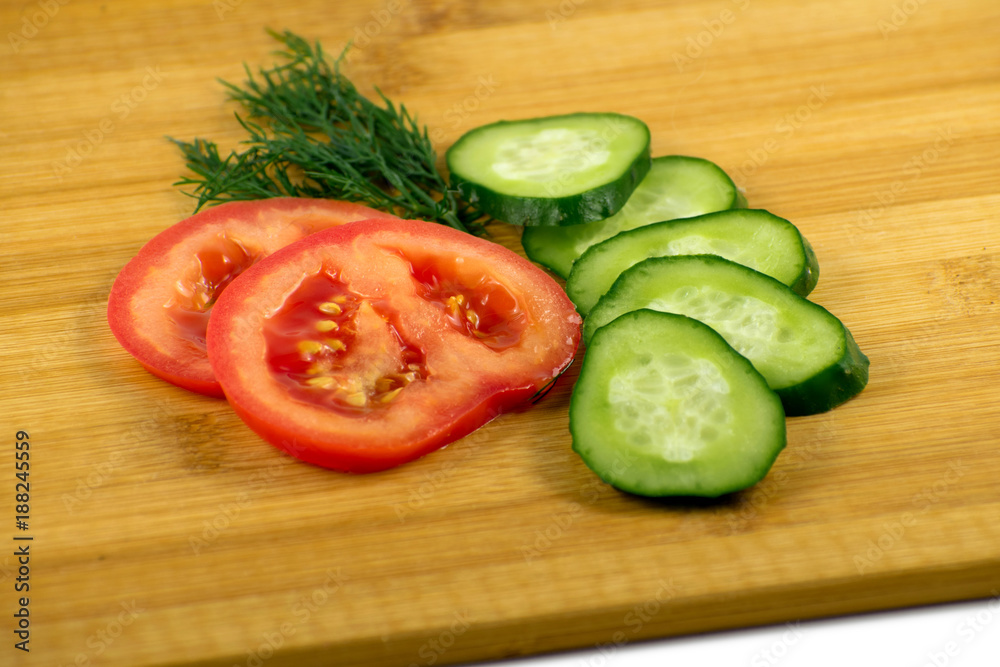 Tomato, cucumber and dill on a wooden board Tomato, cucumber and dill on a wooden board