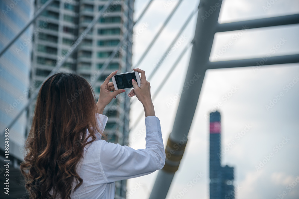 Portraits of Pretty Beautiful Asian woman taking a photo by selfie in urban.