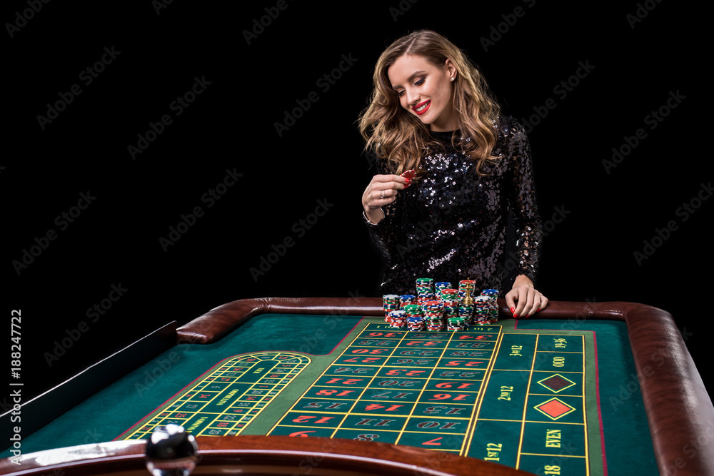Woman playing in casino. Woman stakes piles of chips playing rou Woman playing in casino. Woman stakes piles of chips playing rou