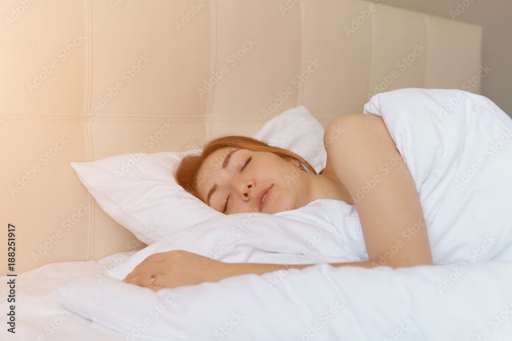 Young woman wakes up in bed Young woman wakes up in bed