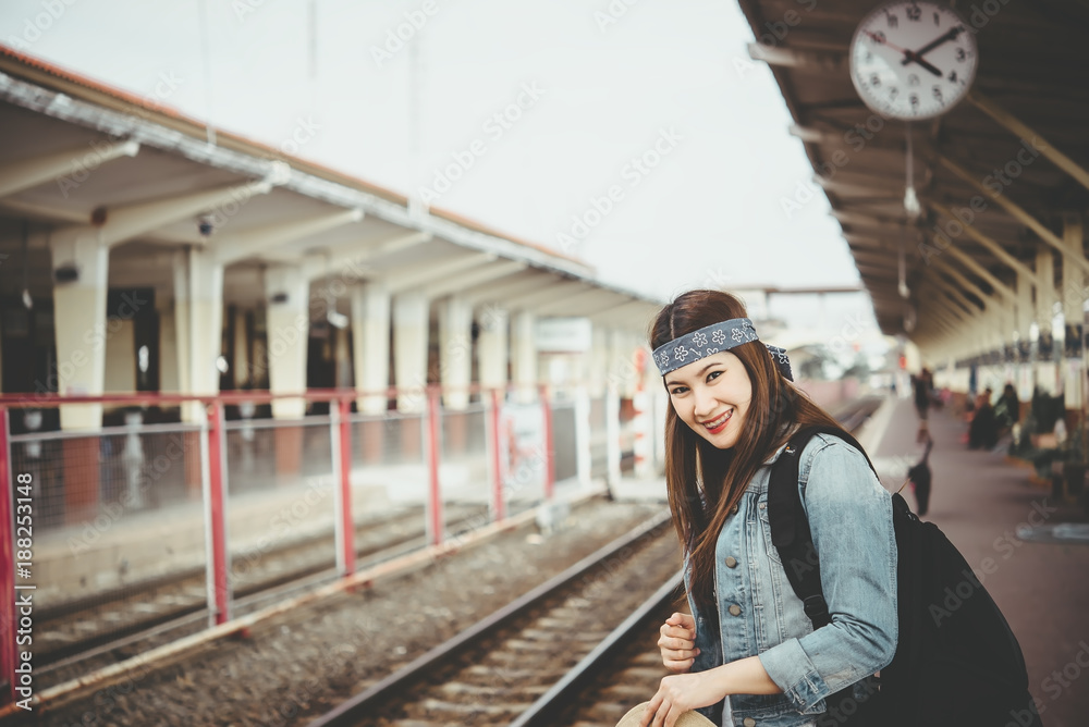 Asian tourist wait train at train station,thailand hipster man go to travel