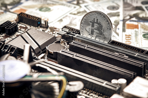 The coin of bitcoin lies on video card with dollars. Exchange bitcoin cash for a dollar photo