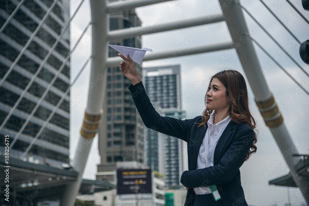 Portraits of beautiful asian woman look confidence is standing and holding paper plane. concept of setting business goals. Portraits of beautiful asian woman look confidence is standing and holding paper plane. concept of setting business goals.