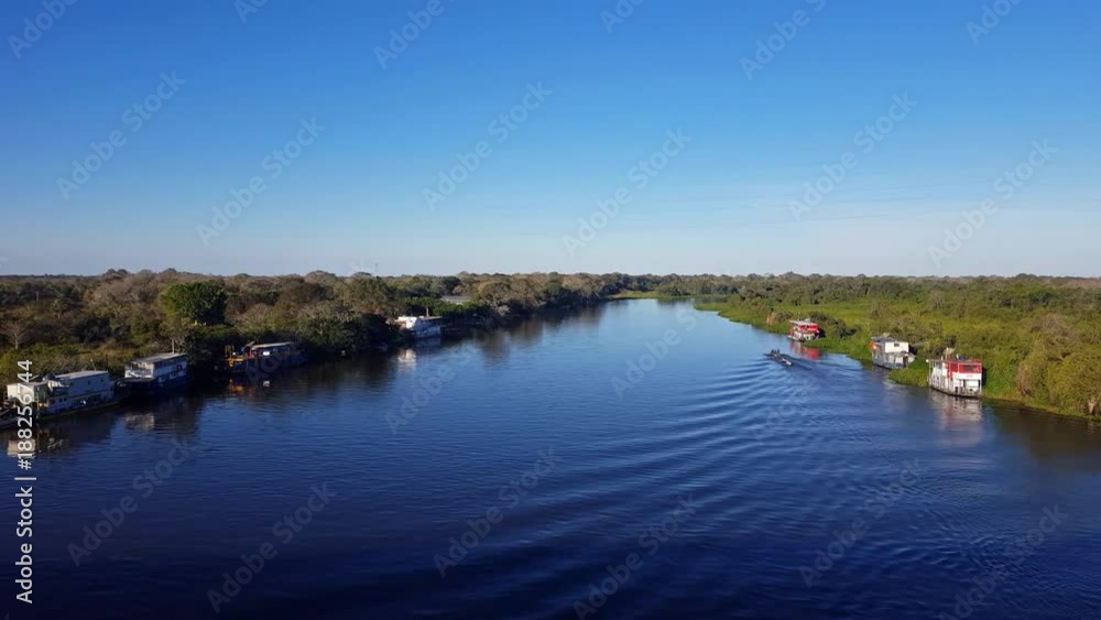 River landscape in the Pantanal Biome. Boat sails. Mato Grosso do Sul state, Central-Western - Brazil. River landscape in the Pantanal Biome. Boat sails. Mato Grosso do Sul state, Central-Western - Brazil.