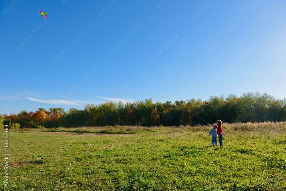 September 20, 2015: children launch a kite in a clearing in the middle of the forest