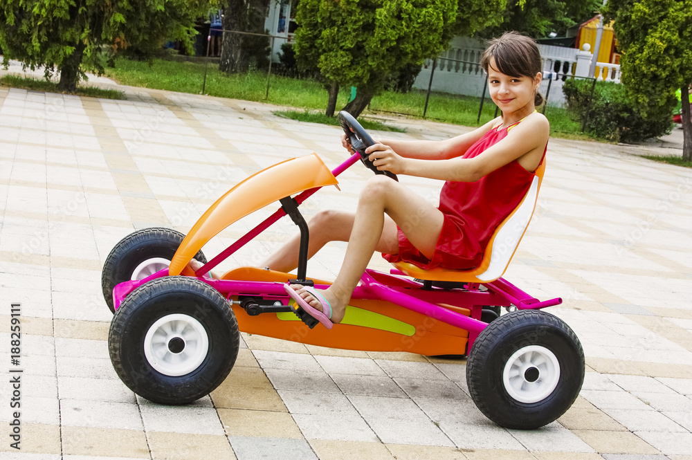 Girl driving a quad bike, four wheel bike, summer bright morning, a sunny day Girl driving a quad bike, four wheel bike, summer bright morning, a sunny day