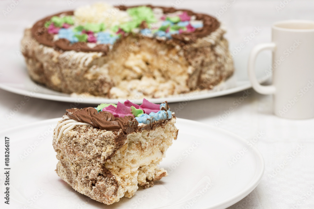 Cake with cream, nuts and meringue with cup of coffee Cake with cream, nuts and meringue with cup of coffee