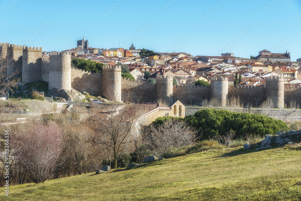 Historic city Avila with its famous medieval town walls surround at the sunny winter day, Spain