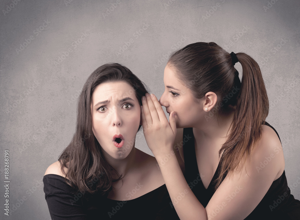 girl telling secret things to her girlfriend girl telling secret things to her girlfriend