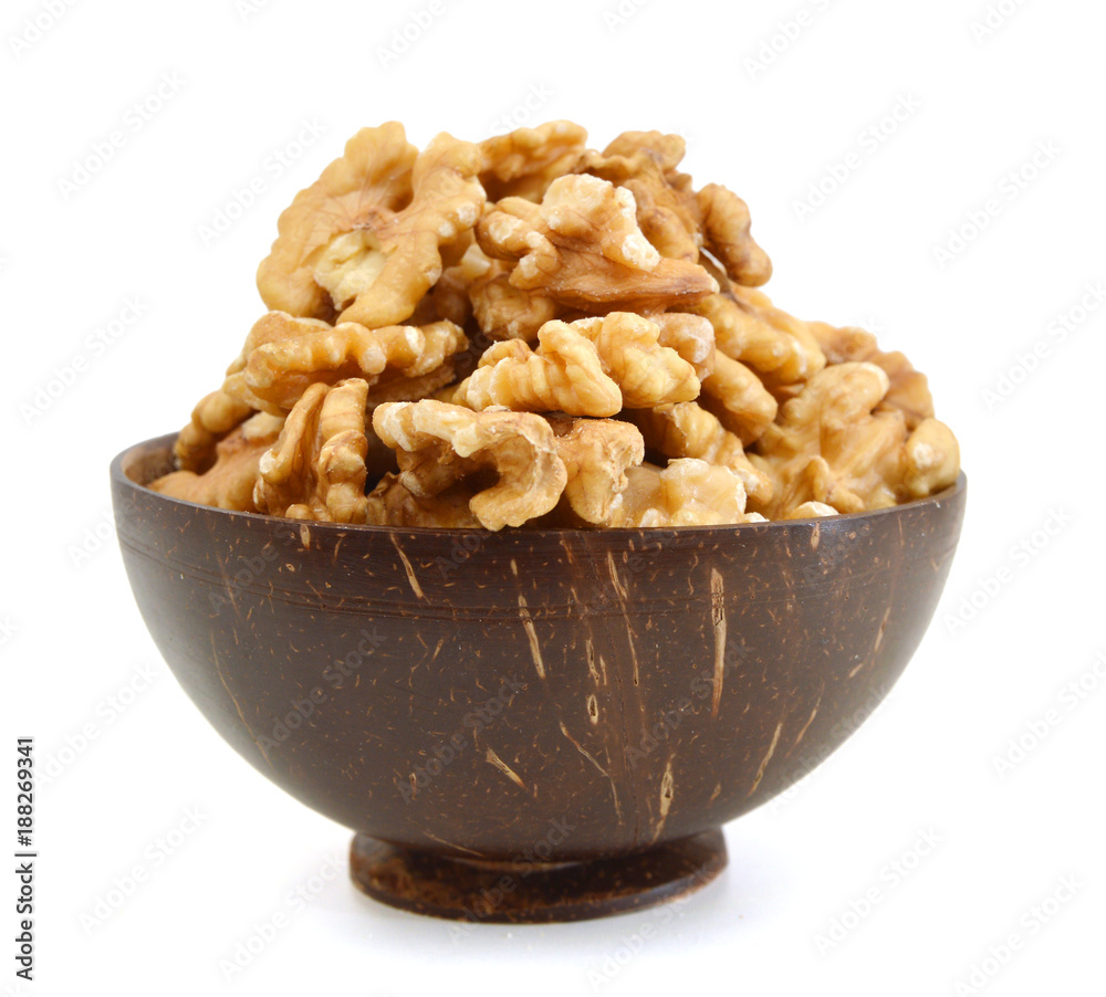 Walnut in wooden bowl on white