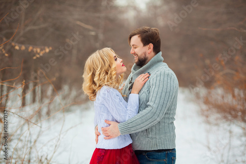 beautiful young couple in love, in light sweaters, walking in the park in cold weather © Alexandr