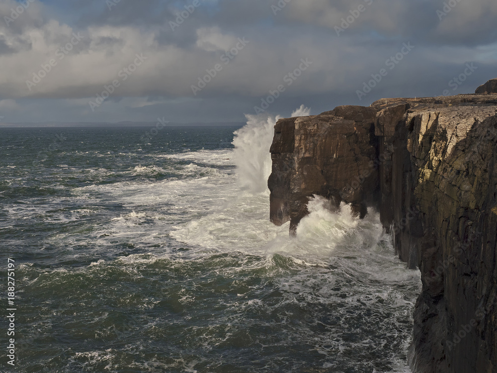 Fototapeta premium Ocean wave hits Mini cliffs, county Clare, Ireland.