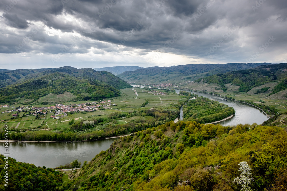 Landscape around the river Donau. Green landscape, dramatic sky, village, hills and horseshoe river.
