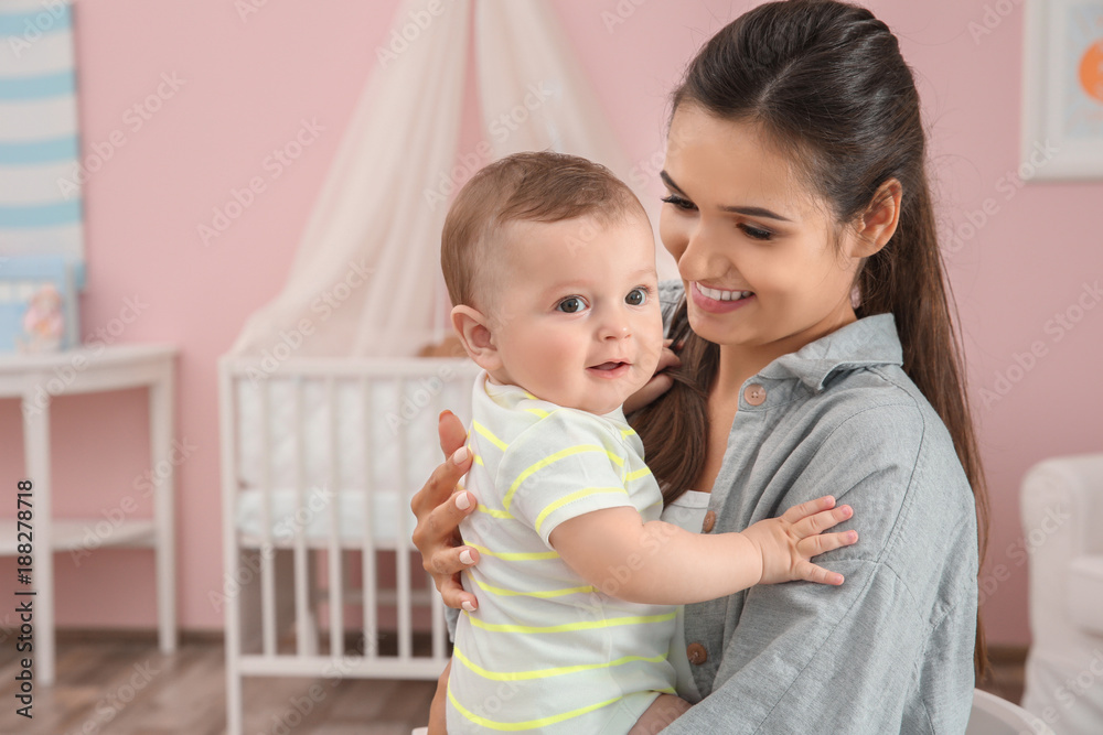 Mother holding cute baby after bathing at home Mother holding cute baby after bathing at home