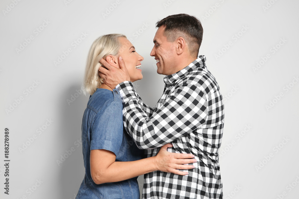 Cute middle-aged couple on light background Cute middle-aged couple on light background