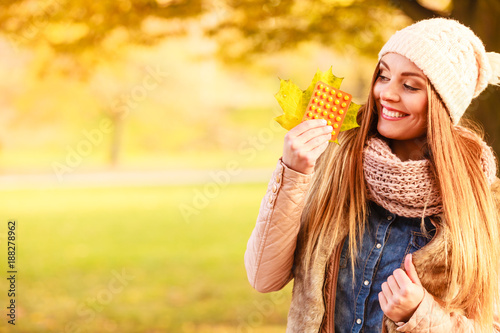 Woman in autumn park holding vitamins medicines