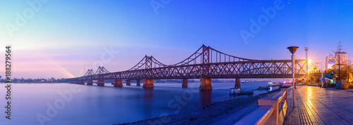 Yalu River Bridge at morning. In the distance is North Korea. Located in Dandong, Liaoning, China.