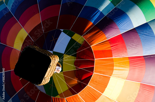 Rainbow-colored hot air balloon and basket from below Fototapeta
