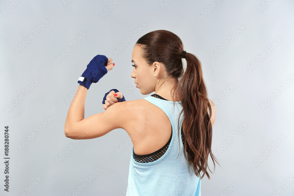 Strong boxer woman on grey background Strong boxer woman on grey background