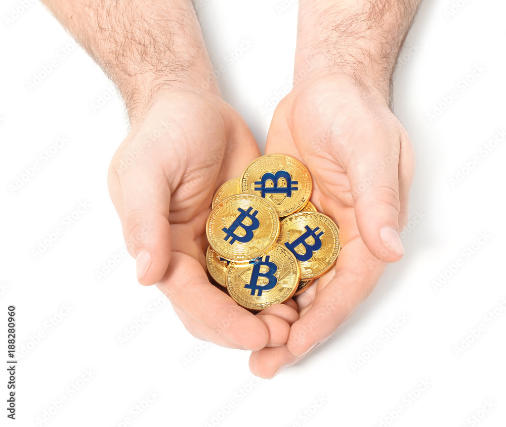 Male hands with golden bitcoins on white background Male hands with golden bitcoins on white background
