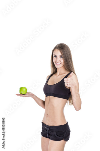 concept of a healthy lifestyle: portrait of a female fitness instructor with an Apple in his hand