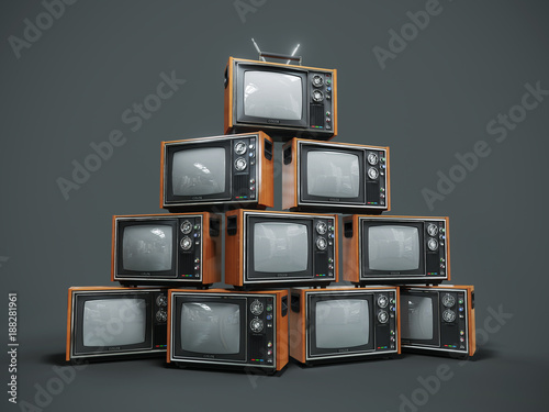 Pile of old retro TVs on dark background photo