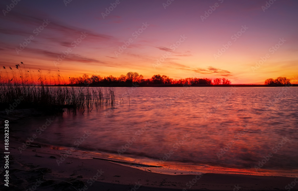 Colorful sunset over sea. Red and orange sky. A long exposure