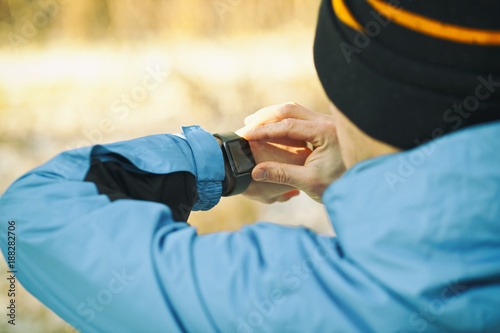 The man is looking on his smartwatches