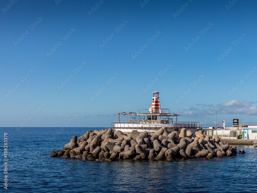 Breakwater blocks in the port of Mogan, Gran Canaria, with the Atlantic Ocean in the background