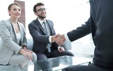 handshake business partners after a business meeting