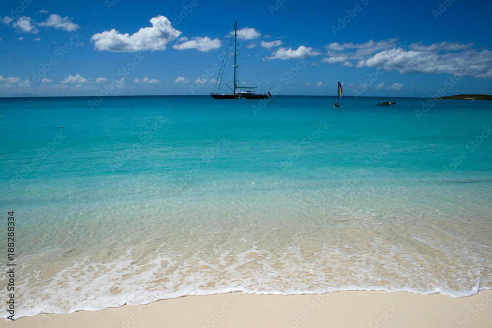 Blue waters blue sky with boats in the caribbean island of Anguilla