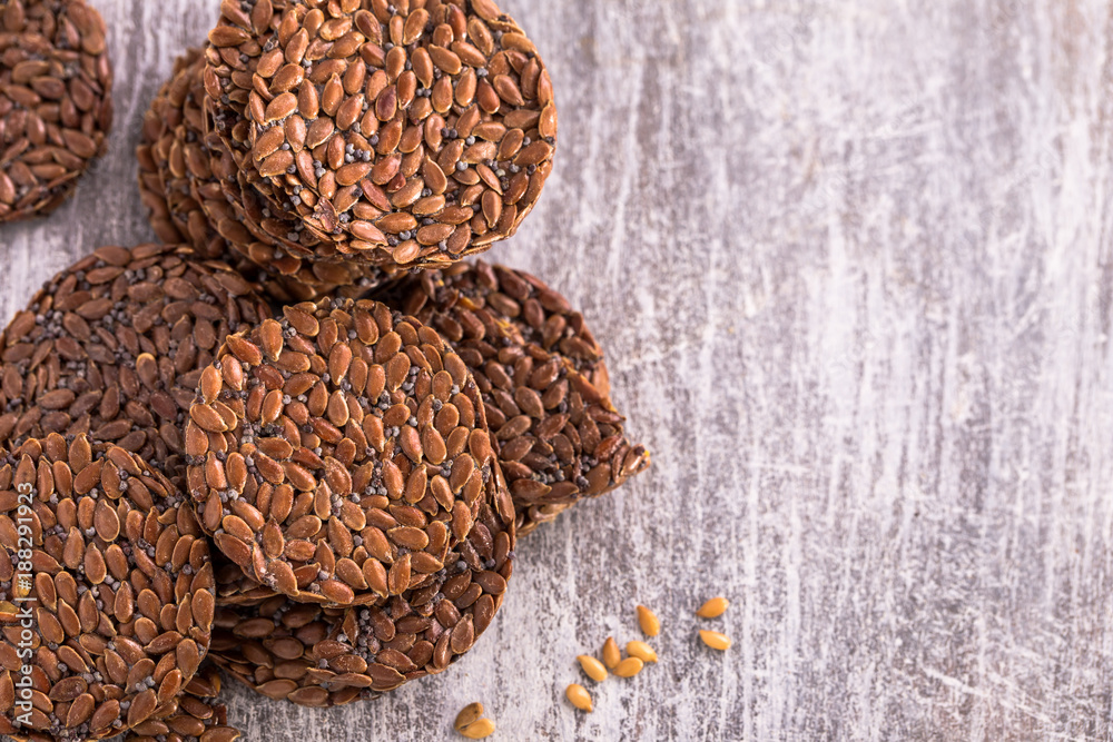 Flax seeds crackers on wooden background with copy space Flax seeds crackers on wooden background with copy space