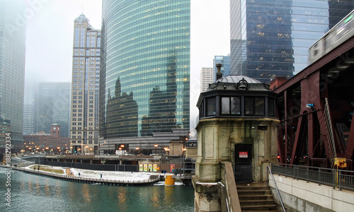 Wallpaper Mural Foggy morning in Chicago with view of frozen Chicago River and bridgehouse alongside a moving elevated train. Torontodigital.ca
