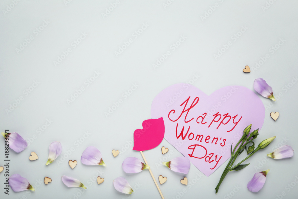 Fototapeta premium Inscription Happy Women's Day with flower petals on grey background