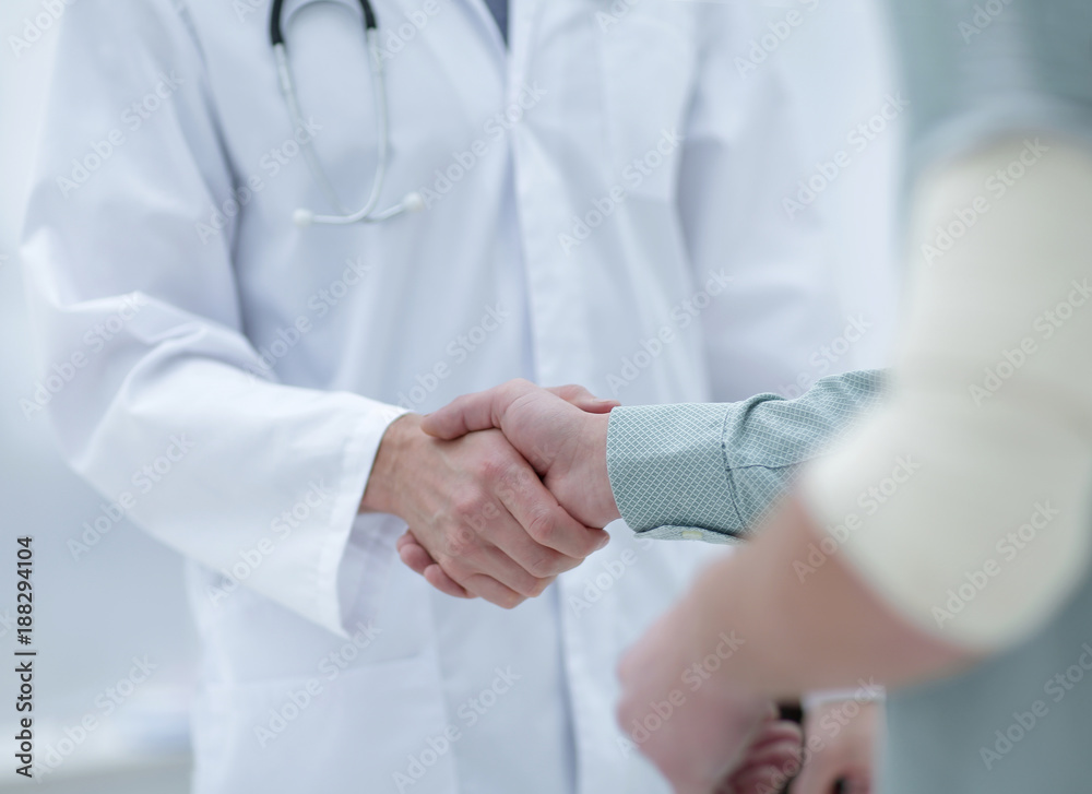 patient shakes hands with his physician patient shakes hands with his physician