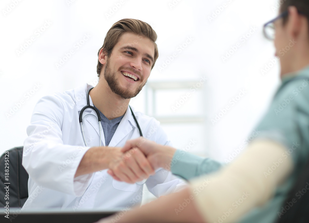 Doctor welcoming a patient in his studio Doctor welcoming a patient in his studio