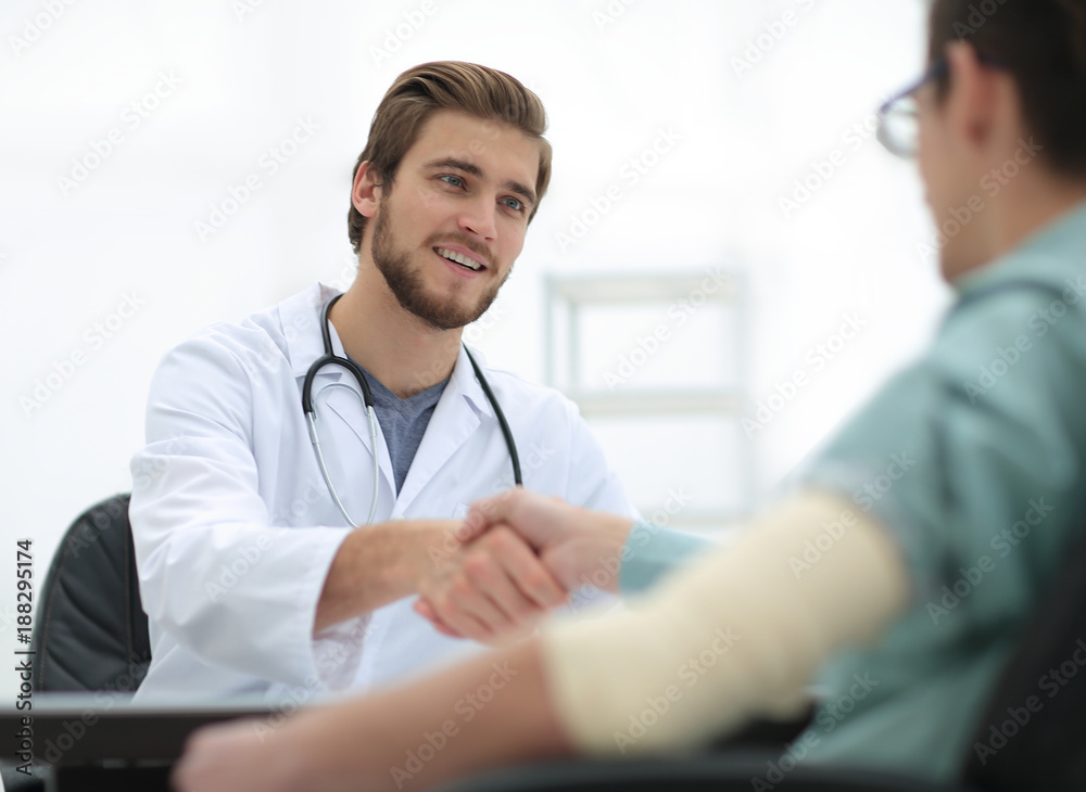 Doctor welcoming a patient in his studio Doctor welcoming a patient in his studio