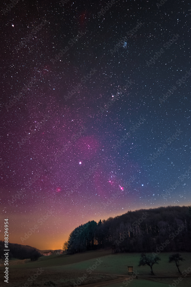 Winter night sky including Barnard’s Loop, the Orion Nebula, the Flame Nebula, the Rosette Nebula, the California Nebula, and the Pleiades as seen from Lampenhain in Germany.
