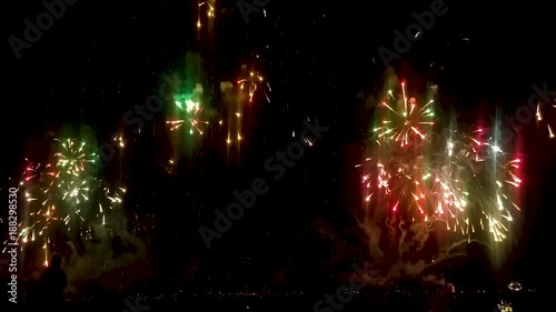 Bright drops of fireworks tearing night sky into millions multicolored stripes photo