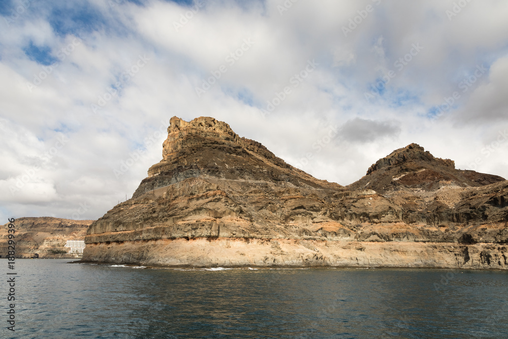 Gran Canaria, Canary Islands in Spain: The powerful mountains at the coast between Puerto de Mogan and Puerto Rico. Layers of volcanic rock. Strata.