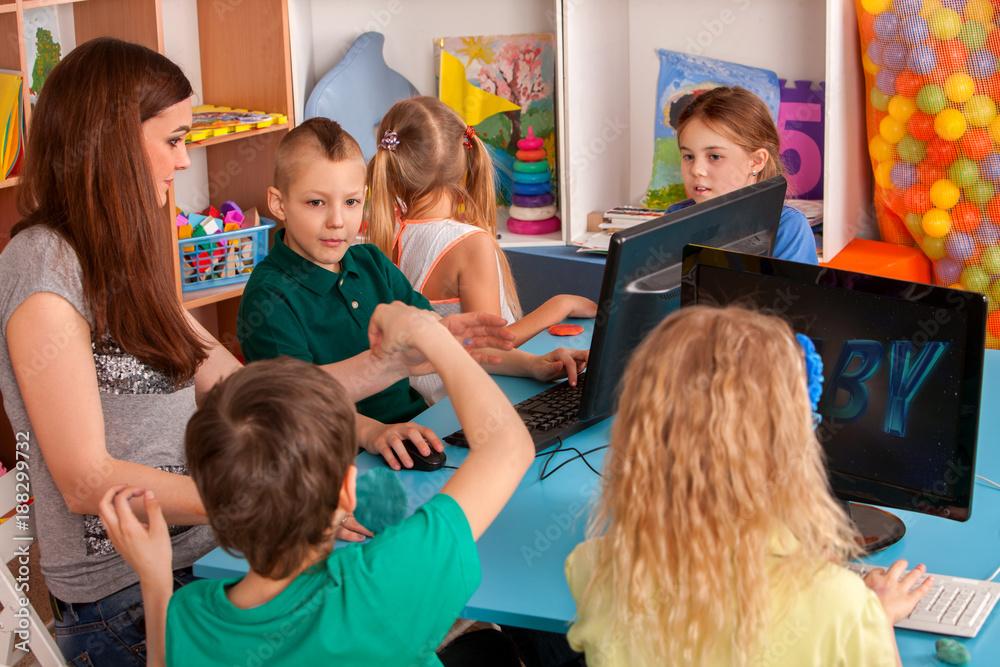 Children computer class us for education and video game. Boys and girls in children's club developing computer games. New technologies alternative to classical training. Online training. Stock Photo | Adobe Stock